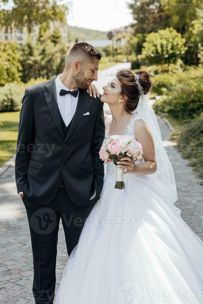 Happy bride and groom after wedding ceremony. Stylish groom. Adult groom. look at each other. Amazing wedding couple photo