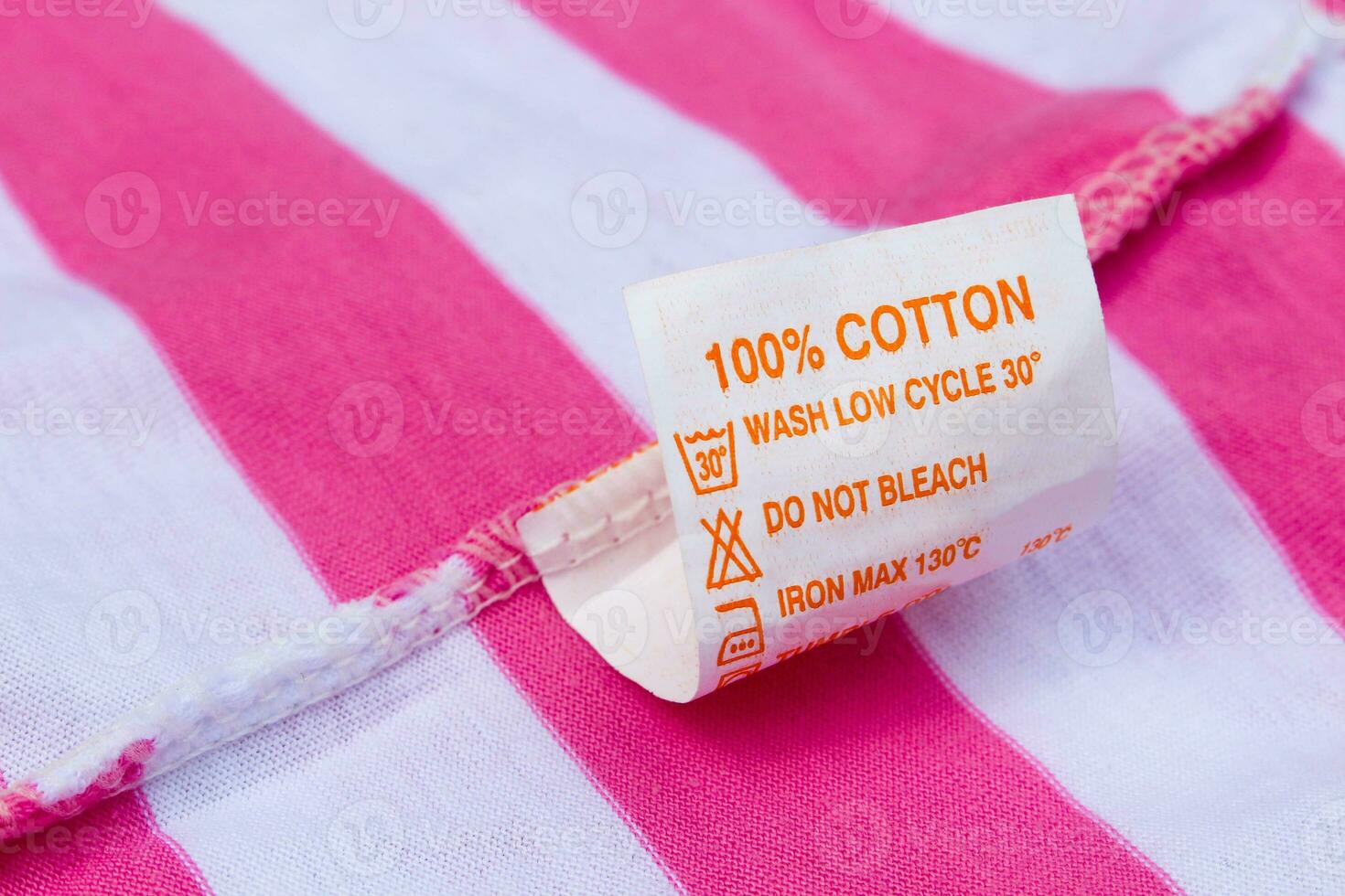 Label 100 cotton on a pink and white t-shirt photo