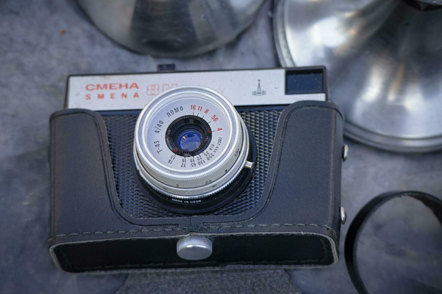 Daugavpils, Latvia 16 09 2023 Old Smena camera in black leather case at flea market photo