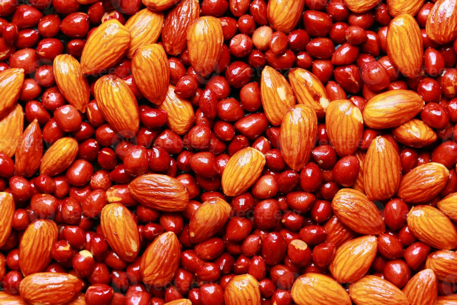 Close-up of almonds and peanuts, Background of big raw peeled almonds and peanuts, Peeled almonds and peanuts closeup background photo