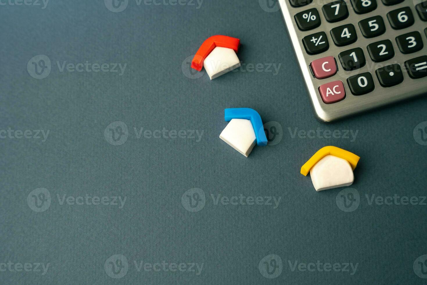 Houses and calculator. Calculate the loan value. Taxes, home budget. Real estate valuation. Buying and selling. Mortgage payments. Utilities and services expenses. photo