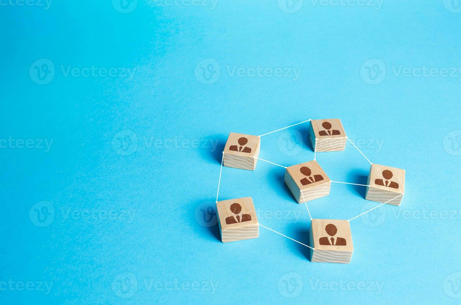 Figures blocks of people connected by lines on a blue background. Communication and interaction, building business relationships. Team building, distribution of responsibilities. Employee network photo