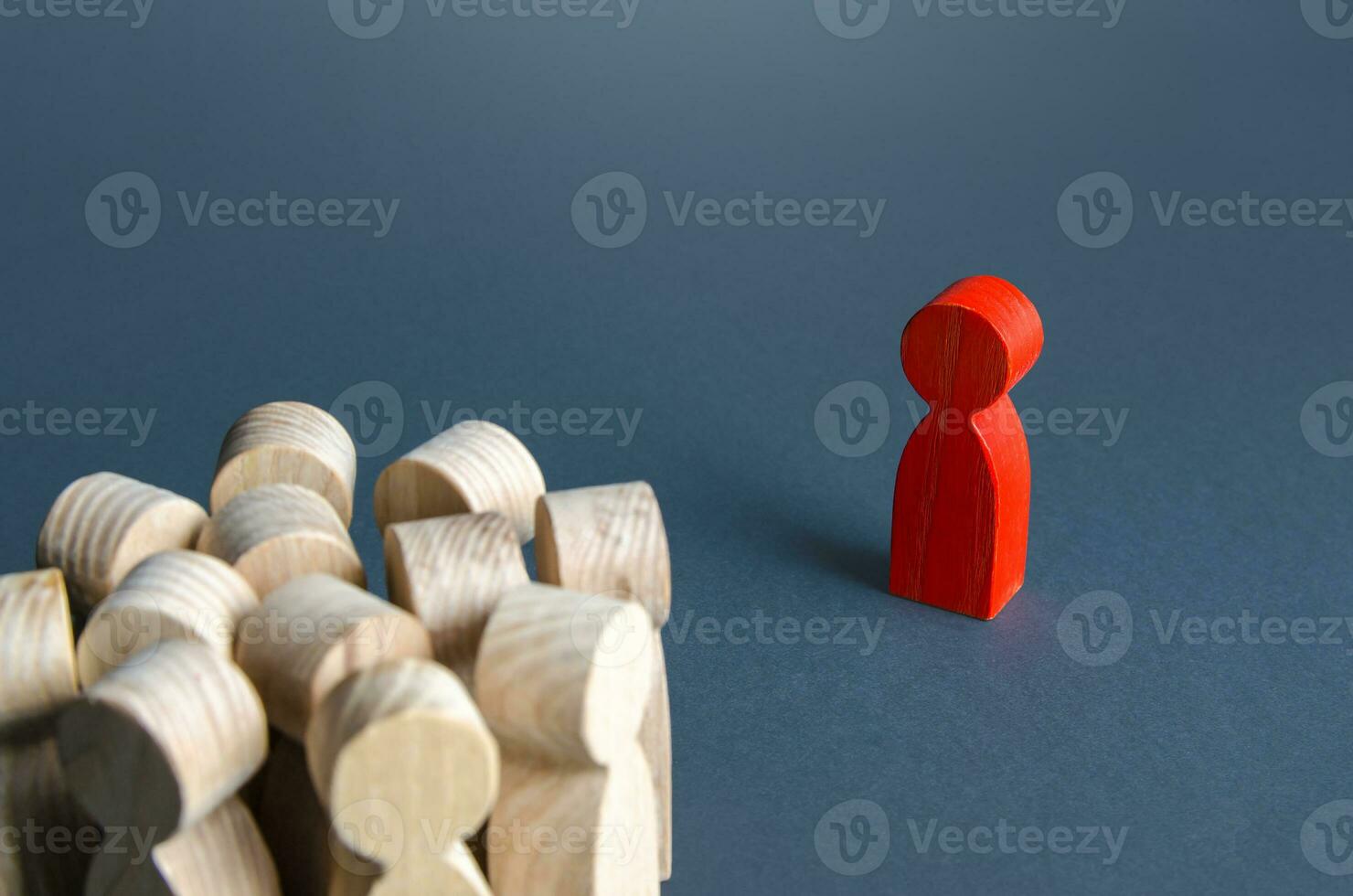 Red man stands aside from crowd of people. Asocial. Integration into society. Self-isolation, contagious. Socialization. A stranger, exiled. The concept of loneliness and lack of communication. photo