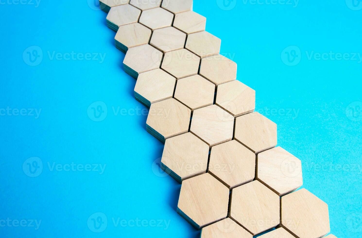 Chain of hexagons on a blue background. Moving forward. Abstraction. Structure, hierarchy. The concept of organization and strength. Unity and Consolidation. Orderly system. Stability, steadfastness. photo