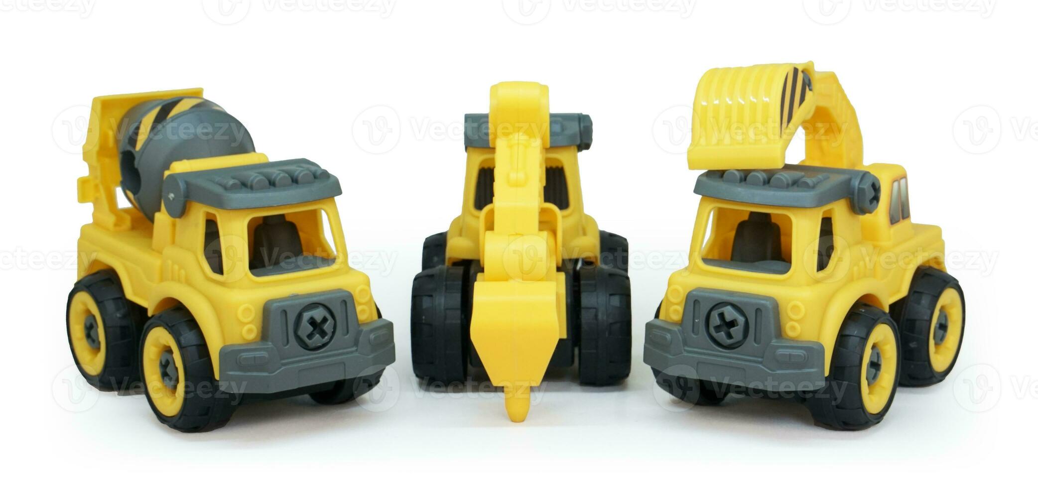 yellow plastic toy of concrete mixer, tractor drill and excavator truck line up isolated on white background. heavy construction vehicle. photo