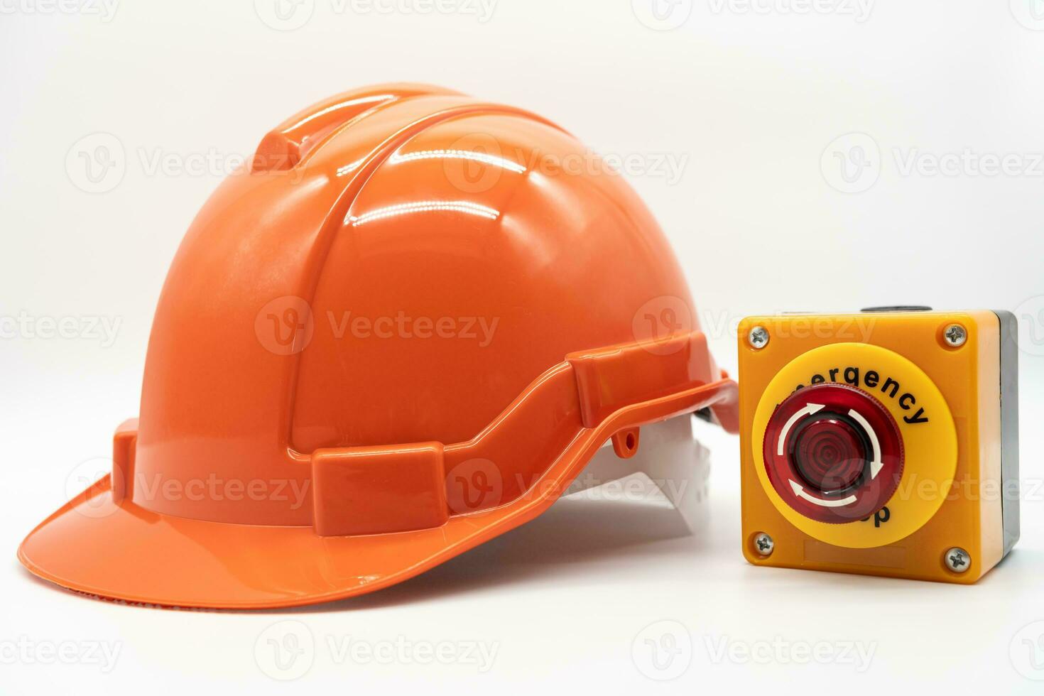 Orange safety hat with Emergency Stop Button isolated on white background. Safety First Concept. photo