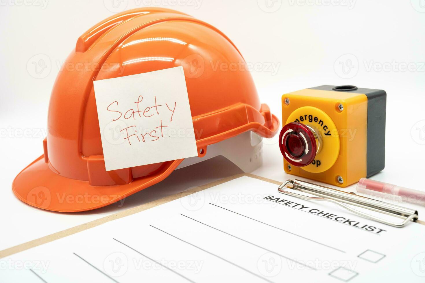 Safety First Text Note. Blank checklist paper during safety audit and risk verification. safety checklist form with Hard hat or Safety hat and Emergency Stop Button. photo