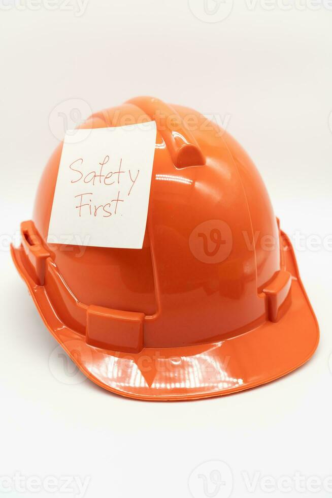 Orange safety hat with message Safety First. hard hat isolated on white background. photo