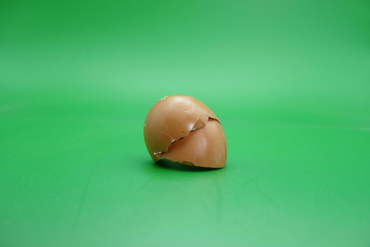 broken eggshell over green background. empty eggshells. photo