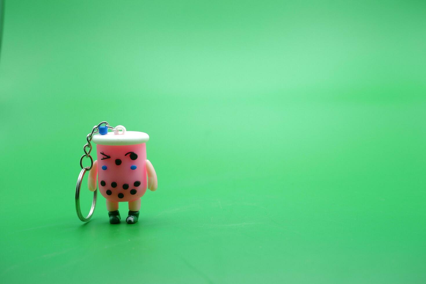 cute key chain isolated on green background. photo