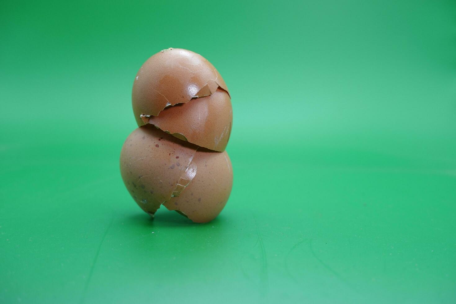 broken eggshell over green background. empty eggshells. photo