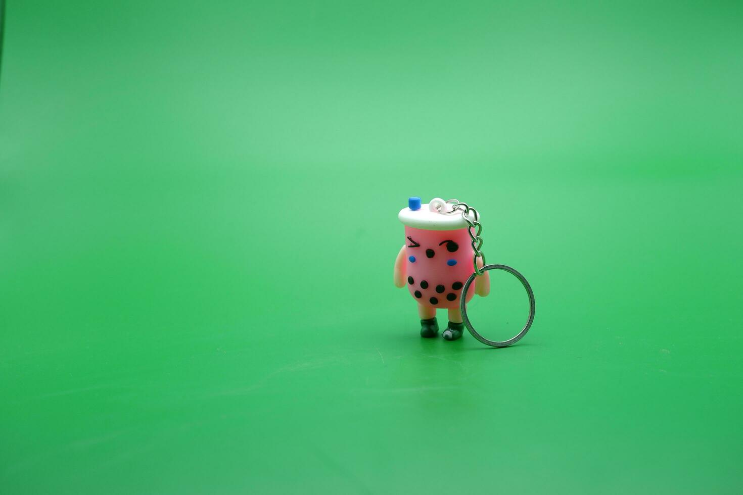 cute key chain isolated on green background. photo