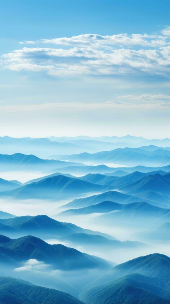 Hazy mountains seen through wispy clouds photo