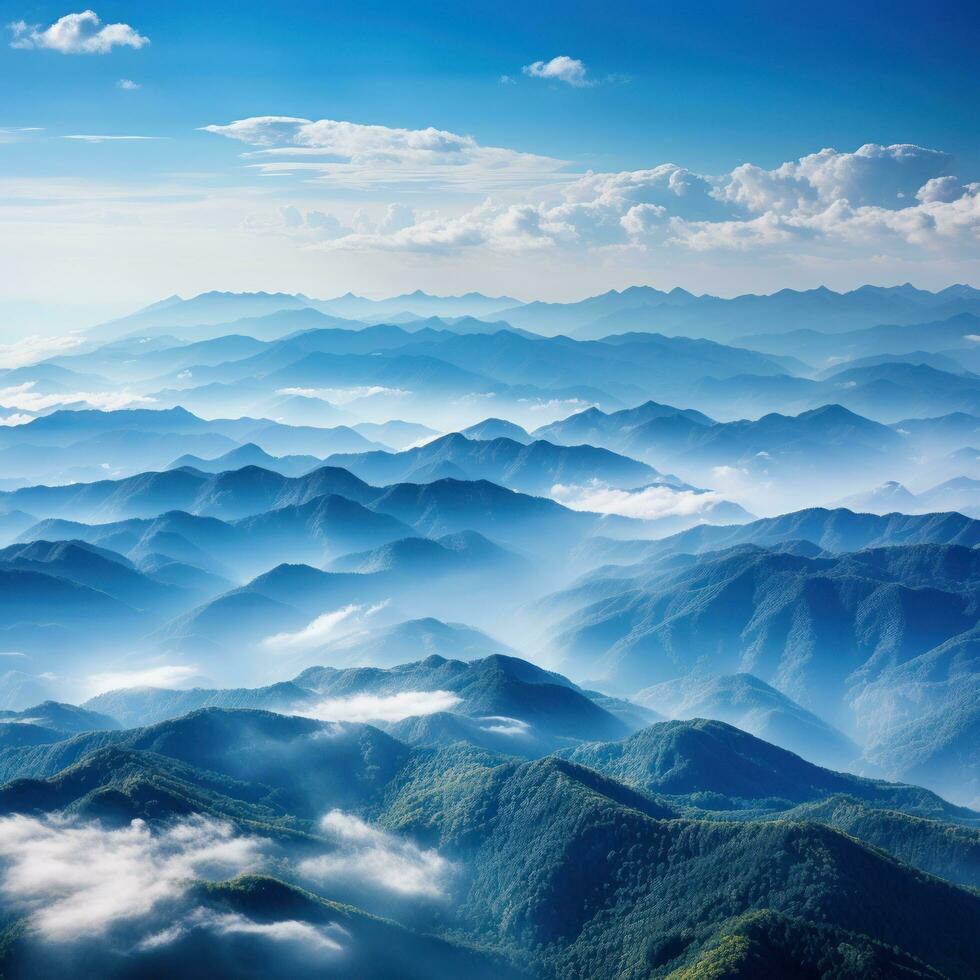 Hazy mountains seen through wispy clouds photo