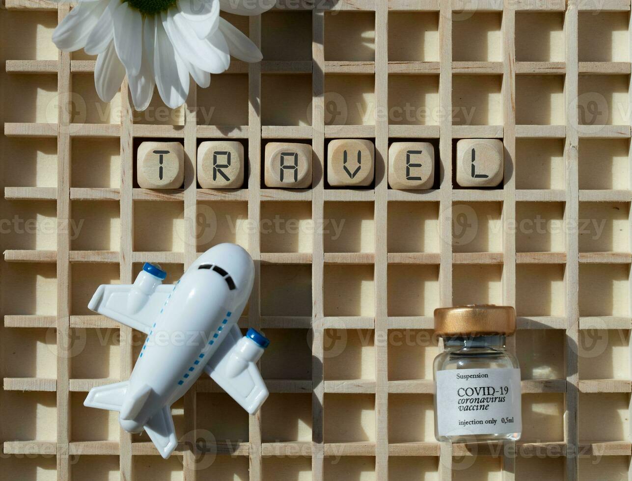 the word 'travel' is written on a board with a photo