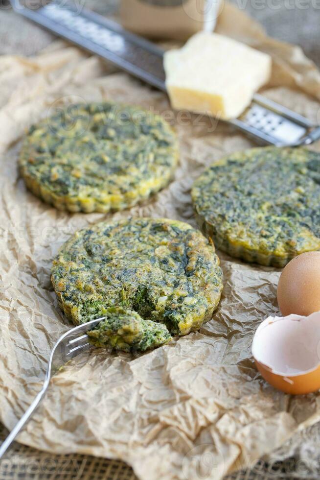 Baked omelette with spinach on a jammed baking paper photo