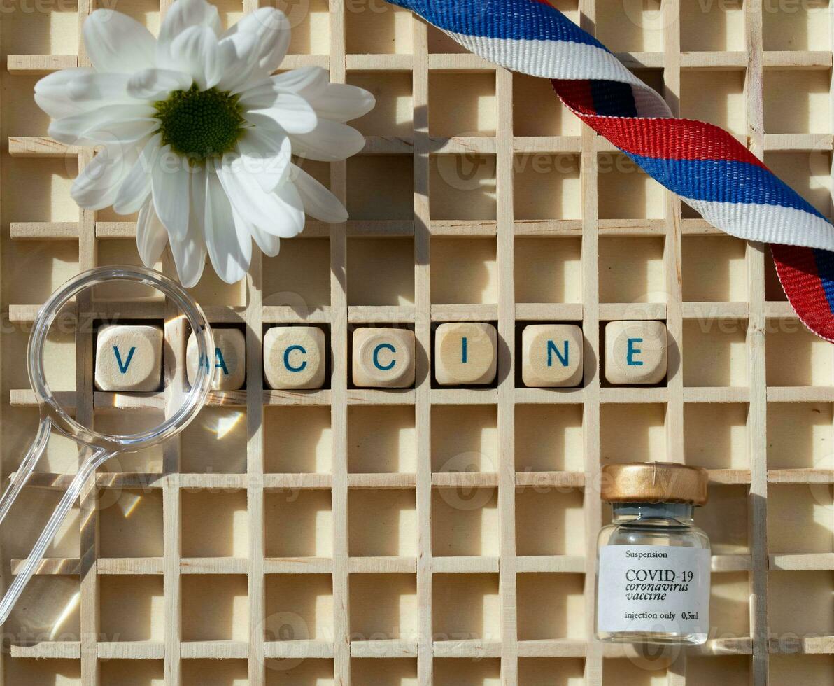 vaccine in a wooden block with a flower photo