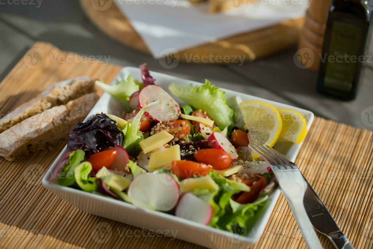 a white square bowl with salad photo