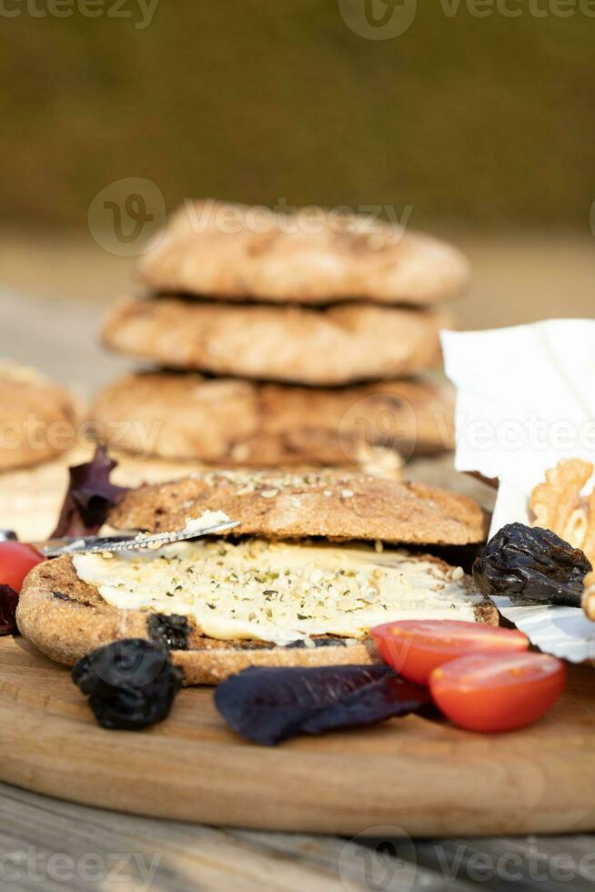 Rye bread rolls with dried plums, butter, hemp seed. Closeup photo