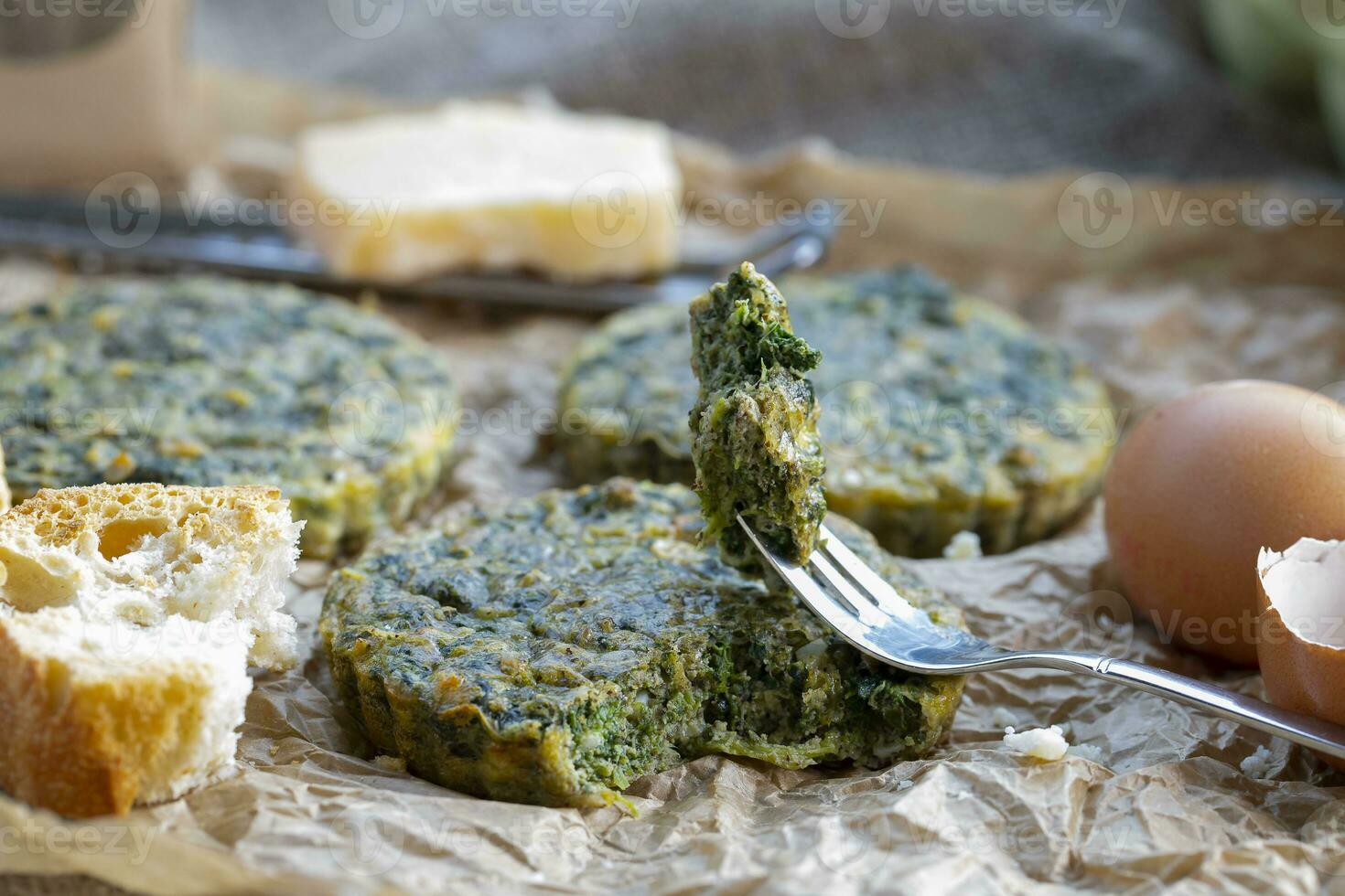 Baked omelette with spinach on a jammed baking paper photo