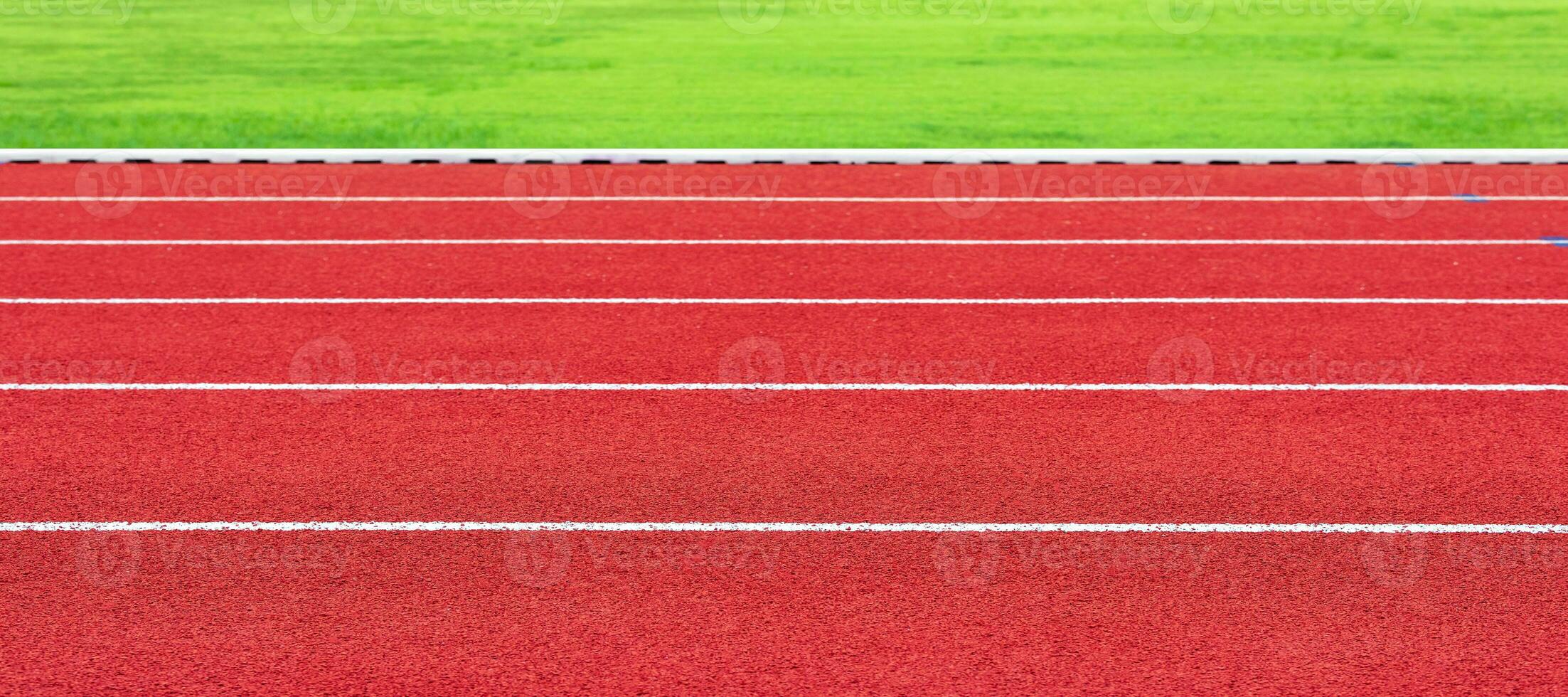 Horizontal image of red running track in an outdoor sports stadium. For sports athletics or exercise photo