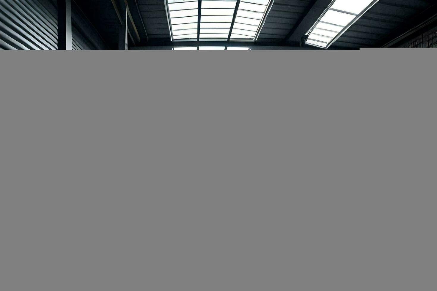 a large warehouse with a skylight in the middle. AI-Generated photo