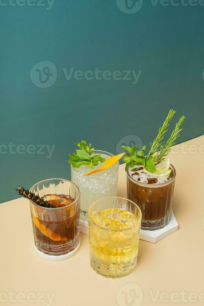 Alcoholic cocktails on podiums on colored backgrounds. Beverage aesthetic concept. photo