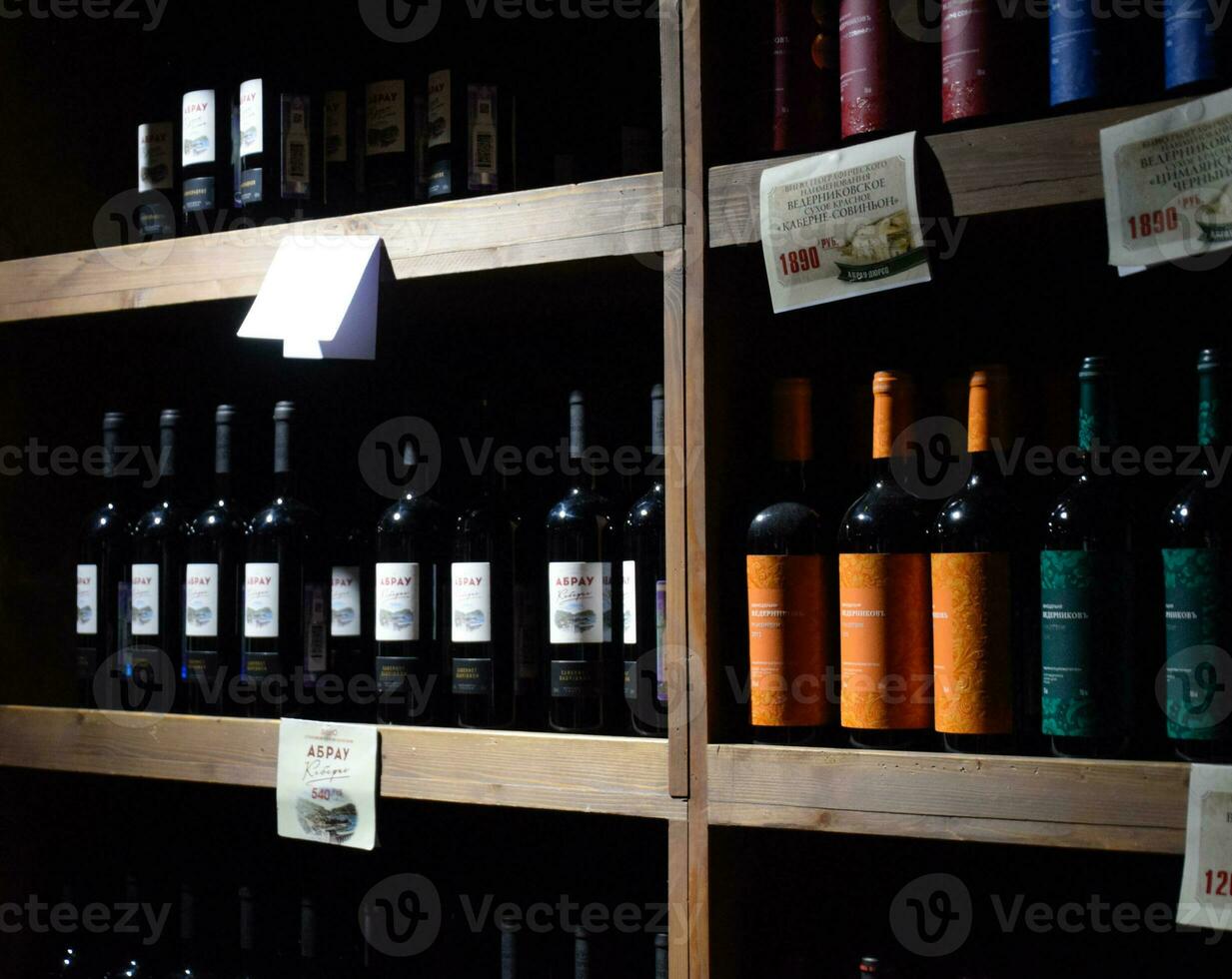 Shelves with wine and champagne in the store winery. Counter at the winery. photo