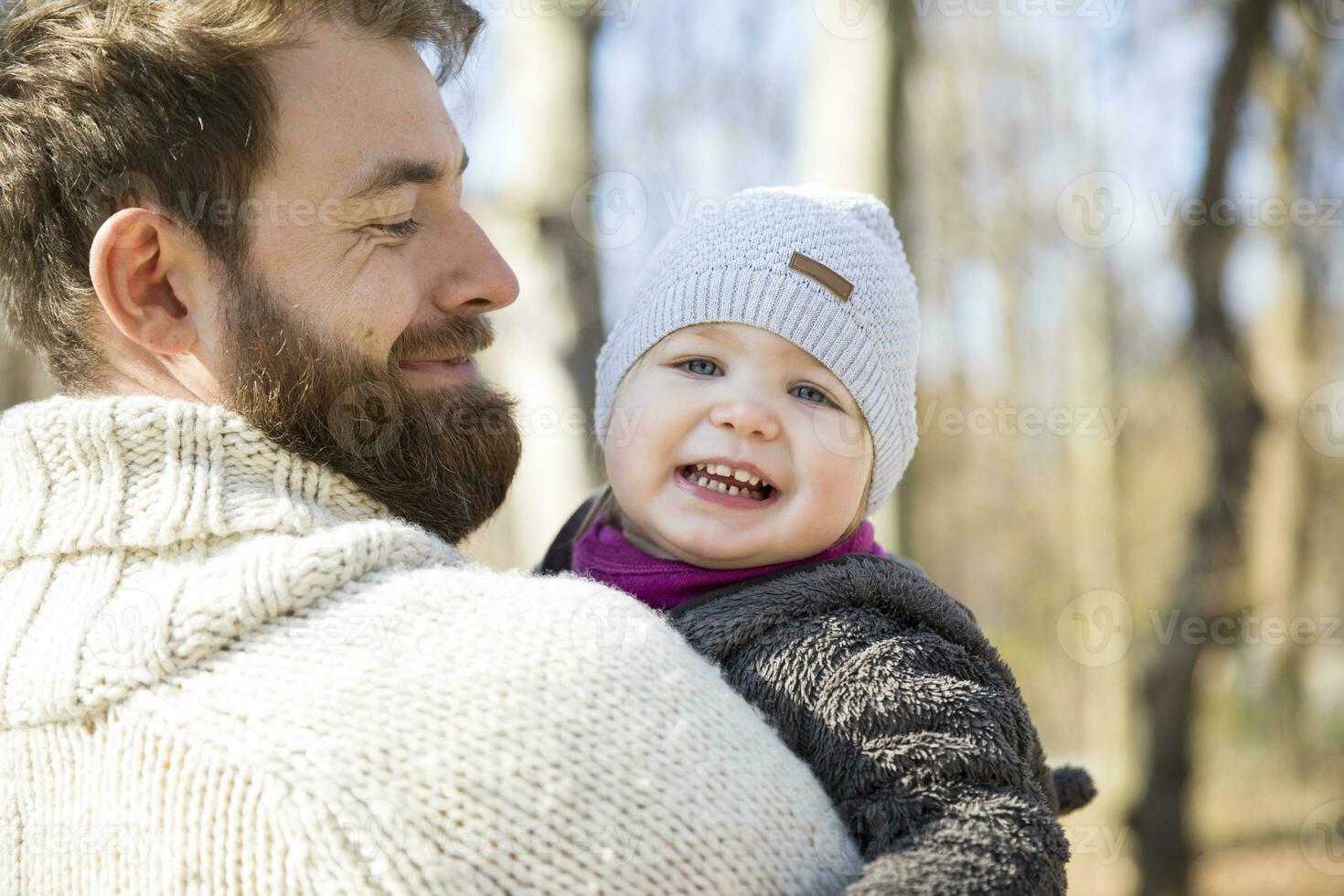Happy father carrying daughter in park photo
