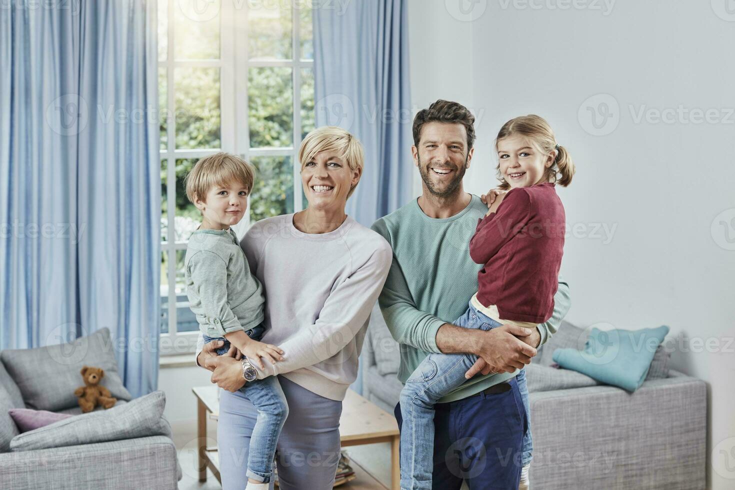 Portrait of happy family with two kids at home photo