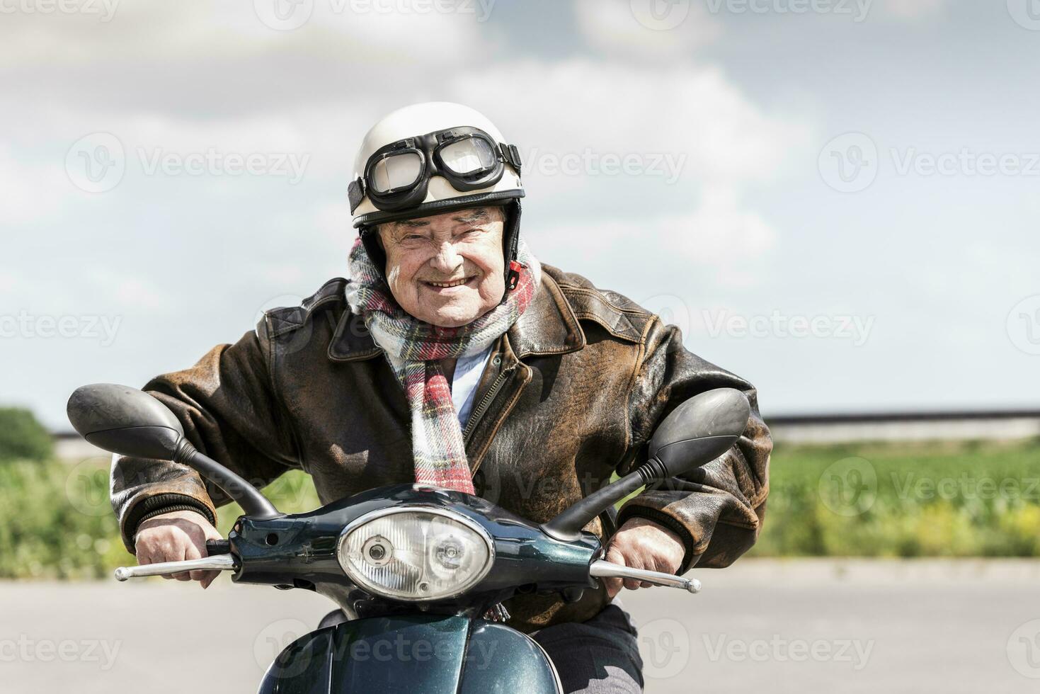 Active senior man speeding on his motor scooter photo