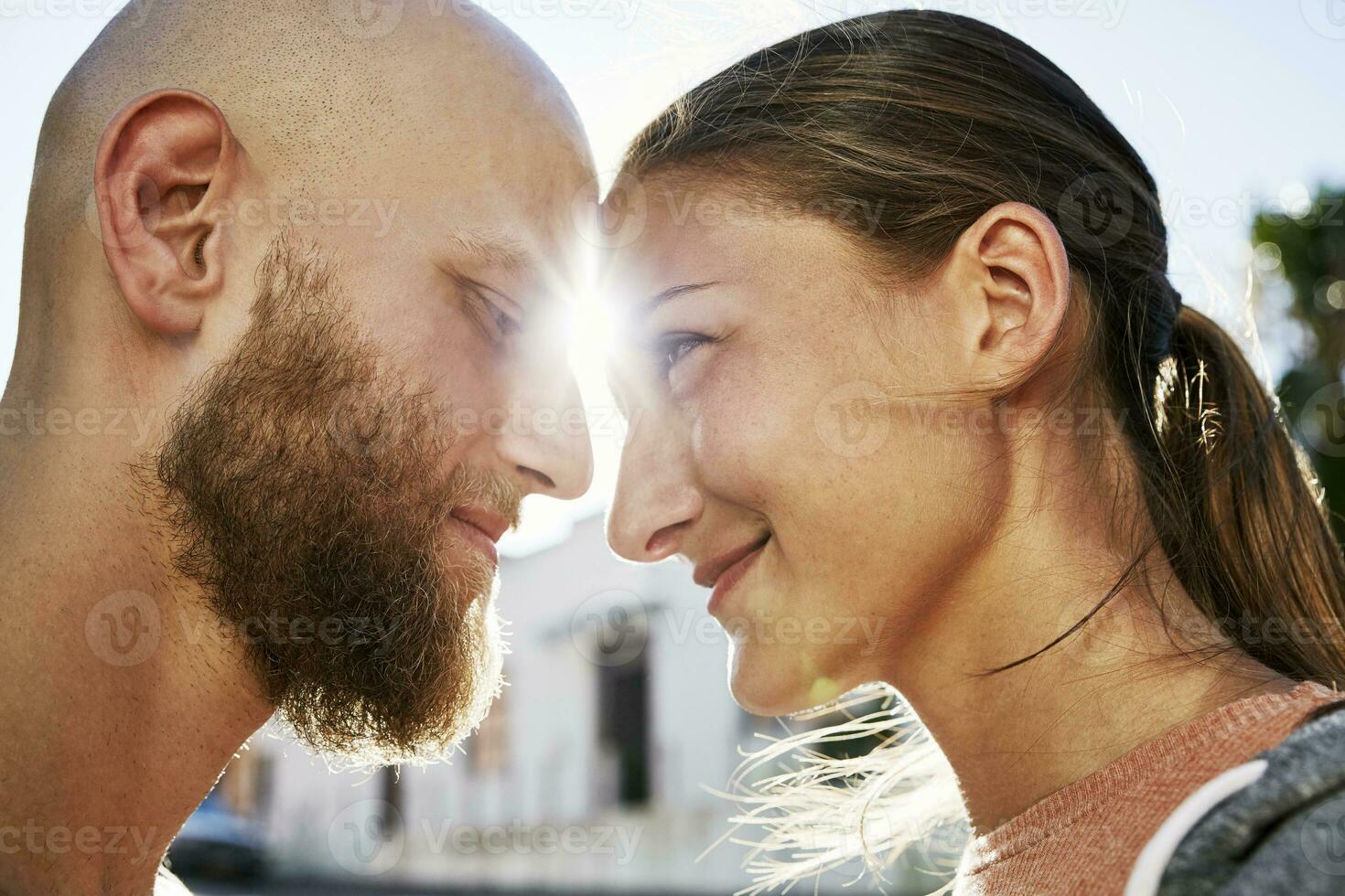 Young couple in love face to face at backlight photo