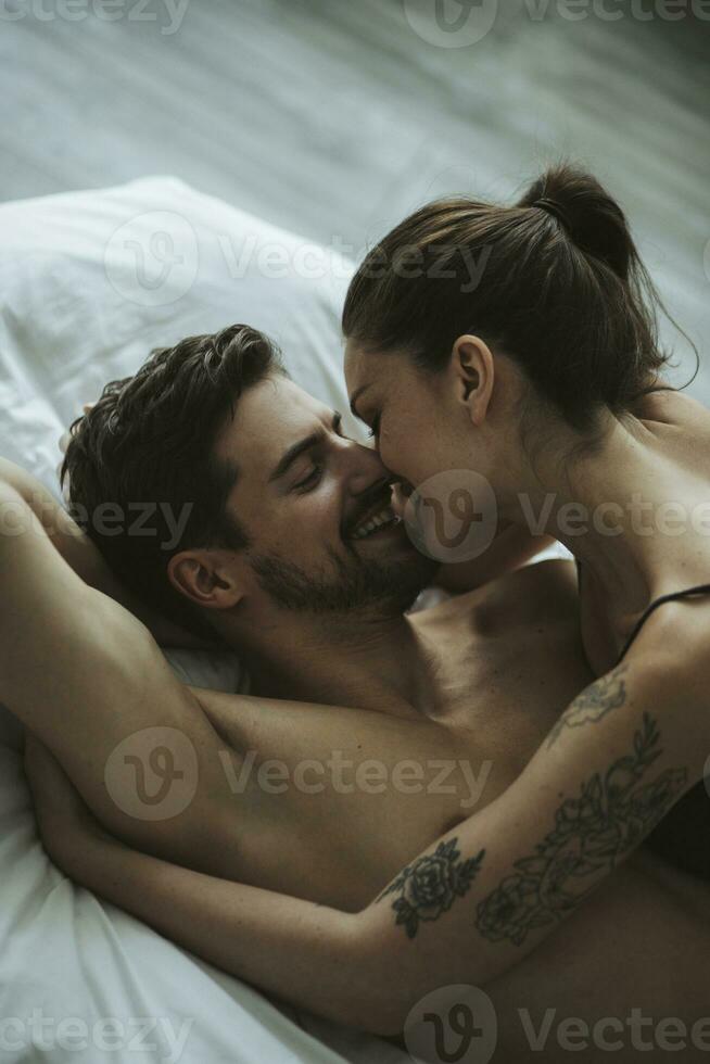 Happy affectionate couple in bed photo