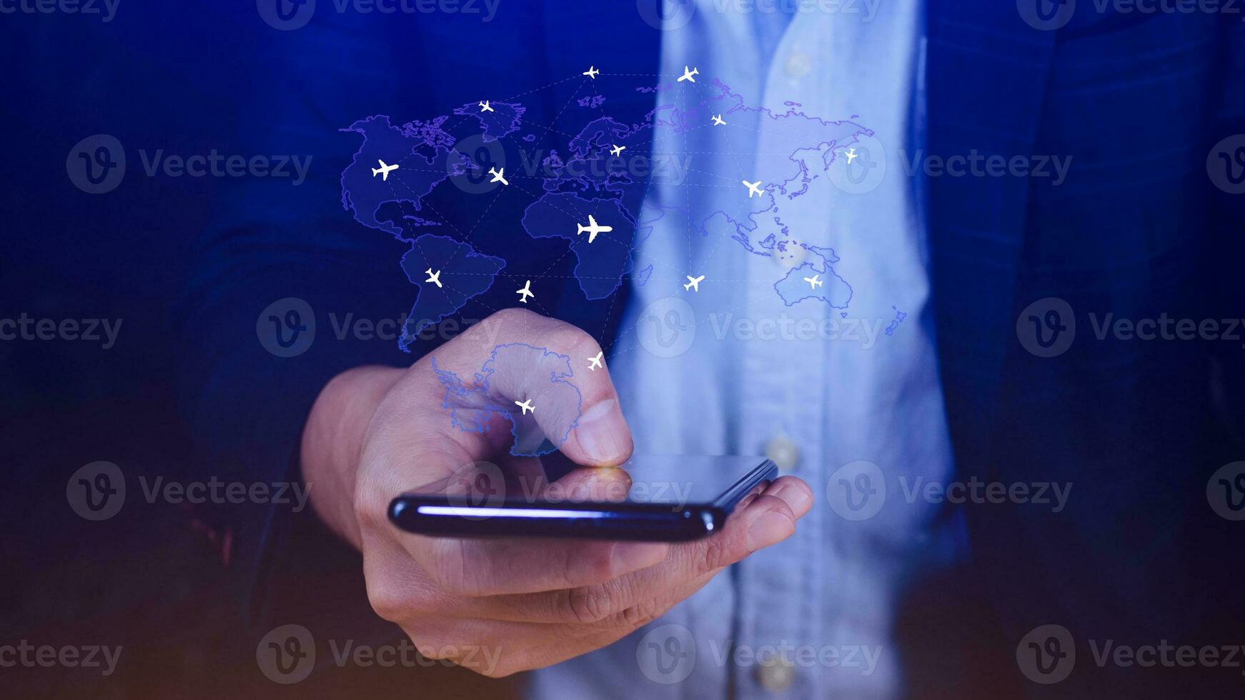Businessman hand pushing flight booking networking with smart phone, Hand pressing light blue world map with flight routes airplane on blue background, Transportation concept. photo