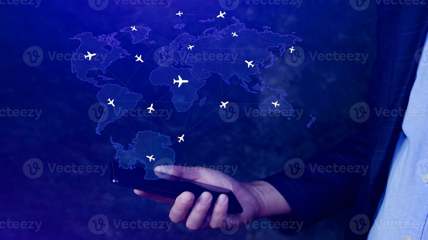 Businessman hand pushing flight booking networking with smart phone, Hand pressing light blue world map with flight routes airplane on blue background, Transportation concept. photo