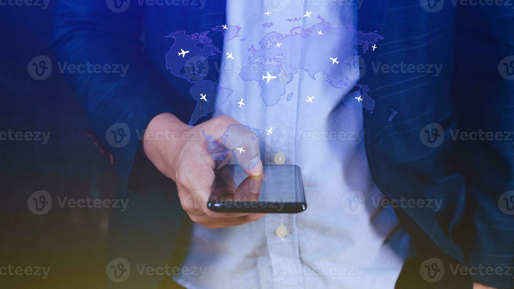 Businessman hand pushing flight booking networking with smart phone, Hand pressing light blue world map with flight routes airplane on blue background, Transportation concept. photo