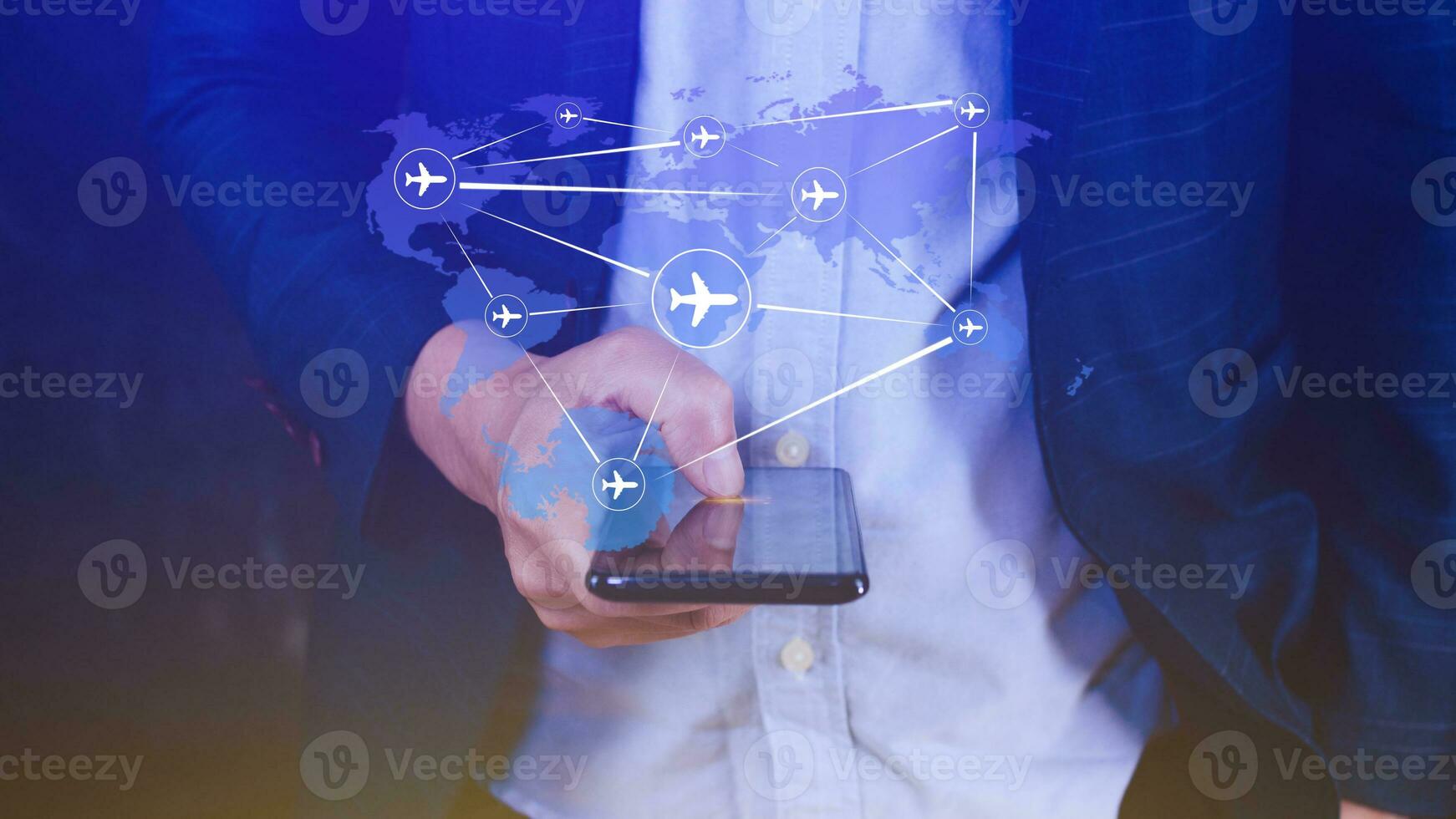 Businessman hand pushing flight booking networking with smart phone, Hand pressing light blue world map with flight routes airplane on blue background, Transportation concept. photo