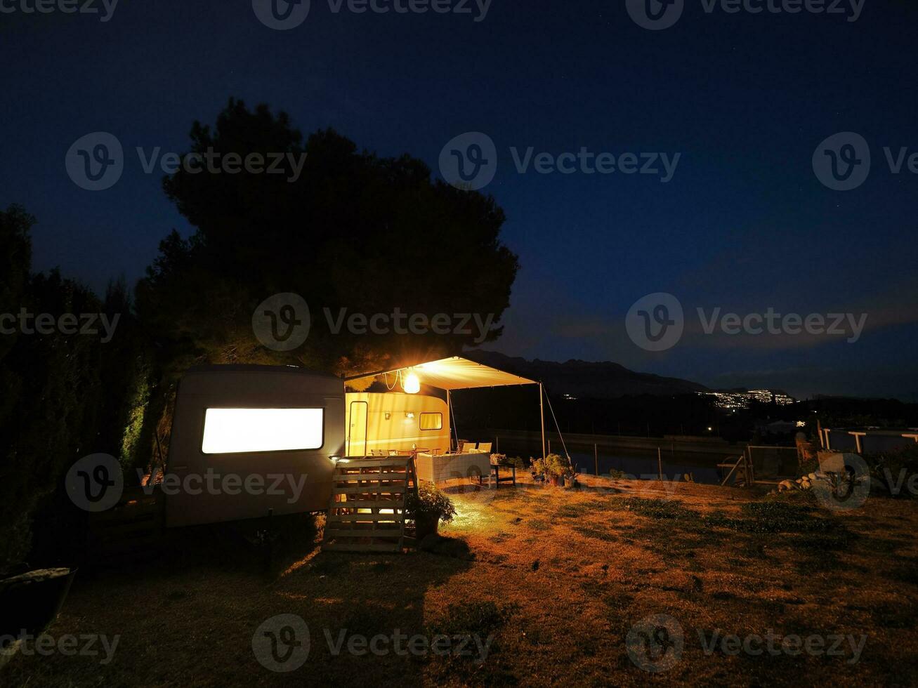 Two vans parked in the forest at night photo