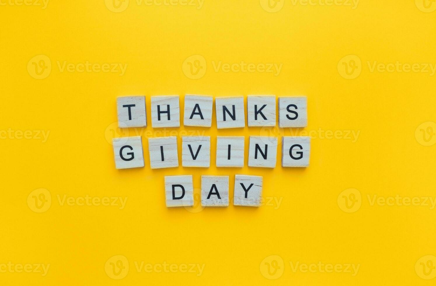 November 24, Thanksgiving Day, minimalistic banner with the inscription in wooden letters on an orange background photo