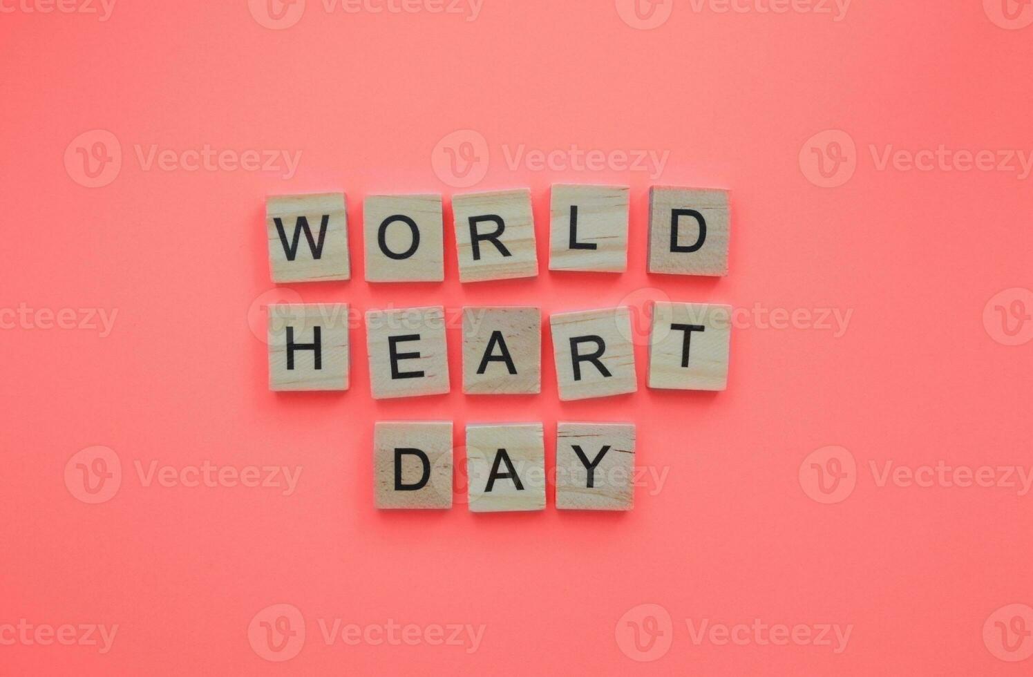 September 29, World Heart Day, minimalistic banner with the inscription in wooden letters photo