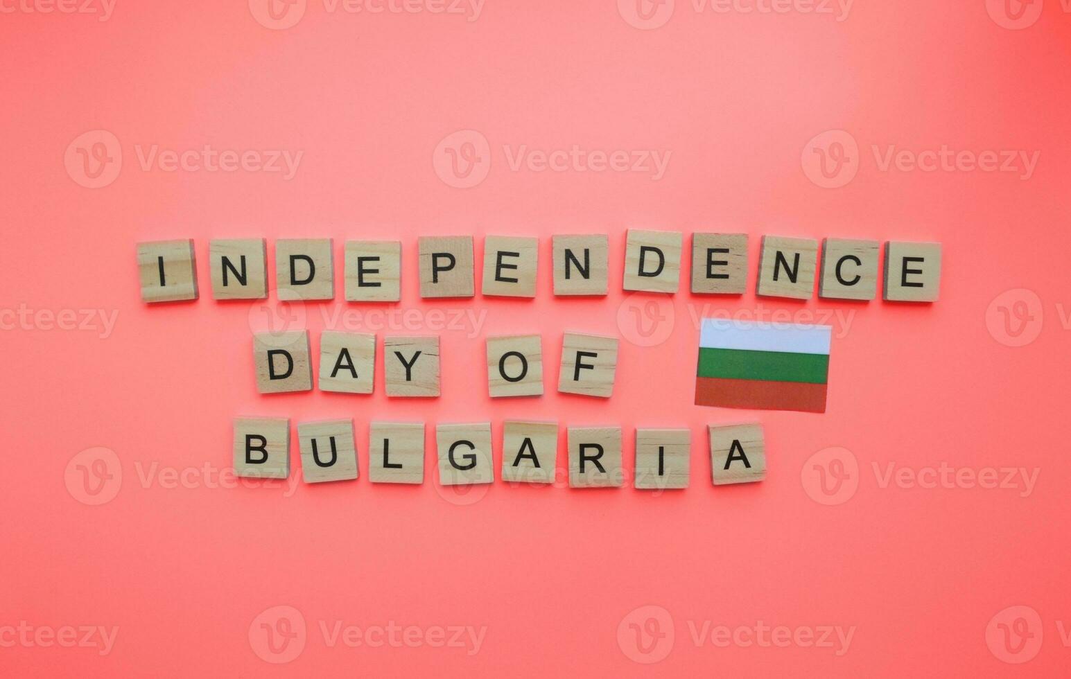 September 22, Independence Day of Bulgaria, flag of Bulgaria, minimalistic banner with the inscription in wooden letters on a red background photo