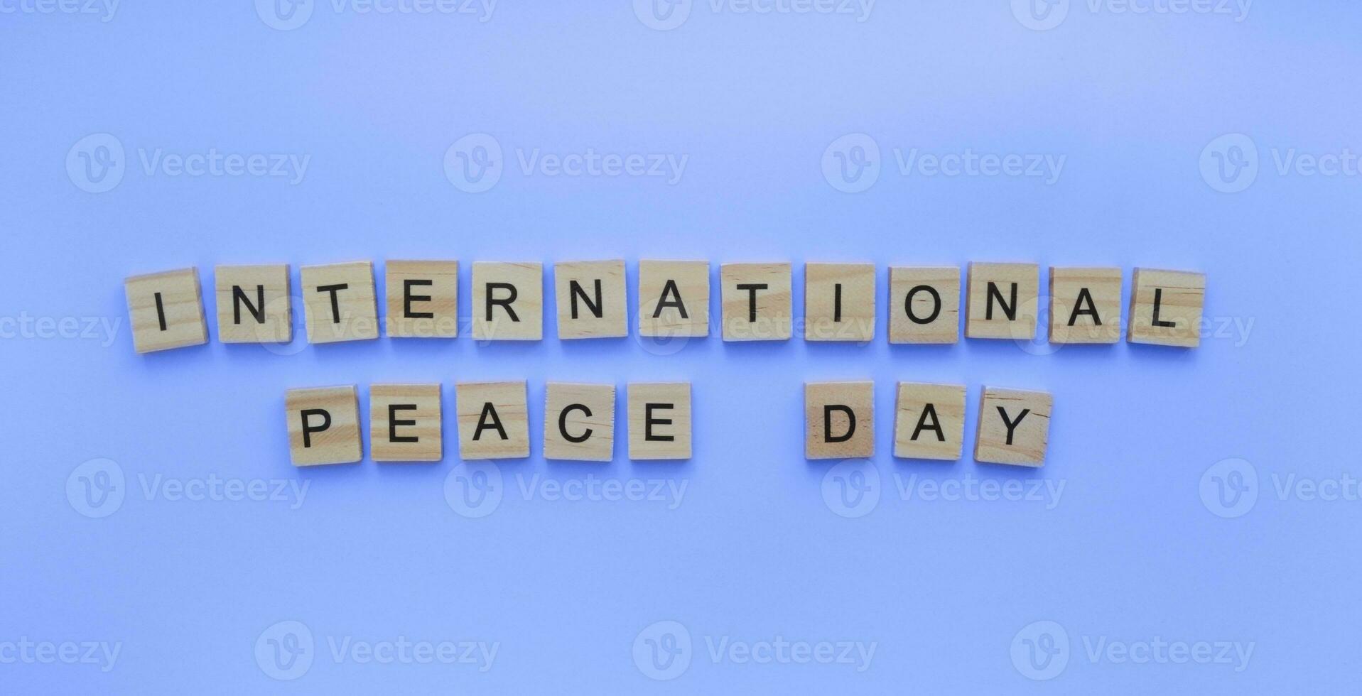 September 21, International Day of Peace, International Peace Day, minimalistic banner with the inscription in wooden letters photo