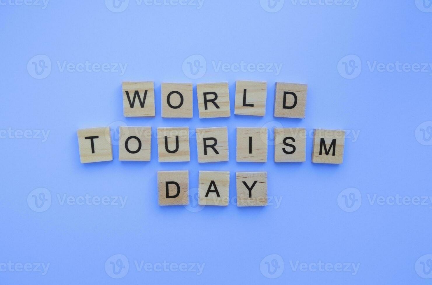 September 27, World Tourism Day, minimalistic banner with the inscription in wooden letters photo