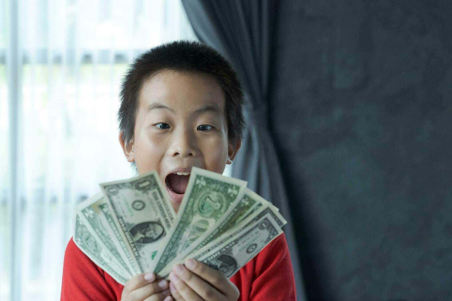 Surprised boy with money photo