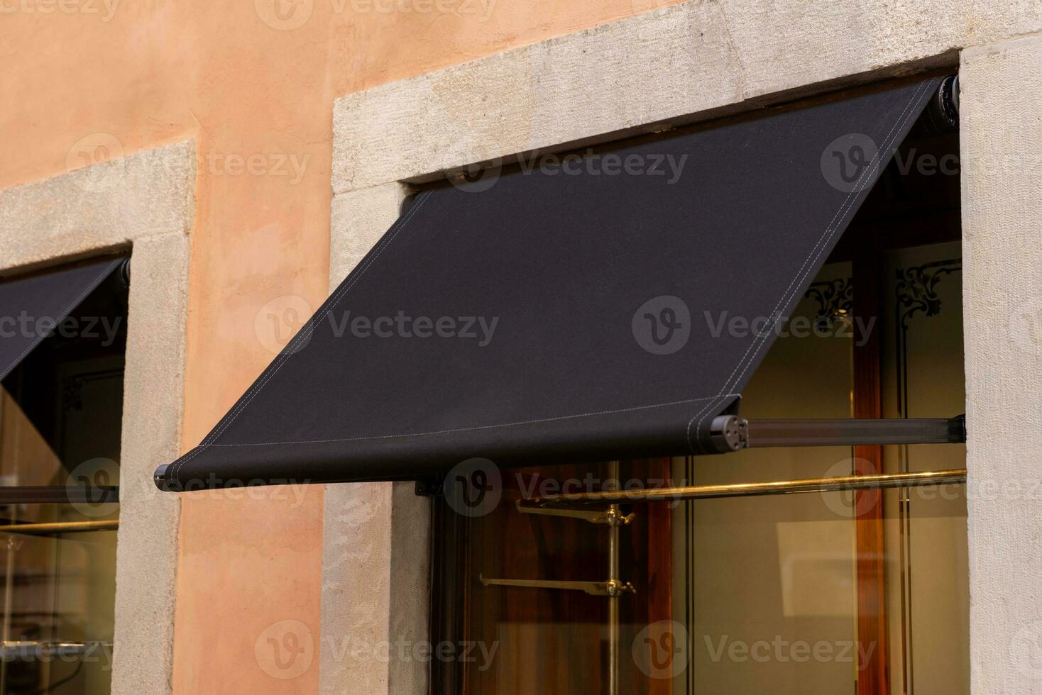 Premium black awning, outside a shop or restaurant, presenting an excellent space for logo mockup promotion photo