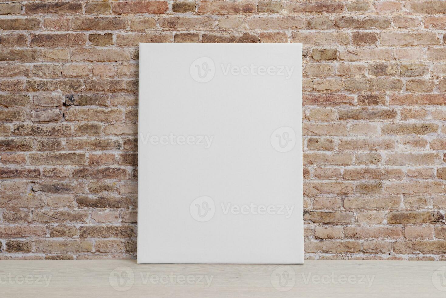 Blank art canvas leaning against the brick wall. Clean surface for mockup, art presentation photo