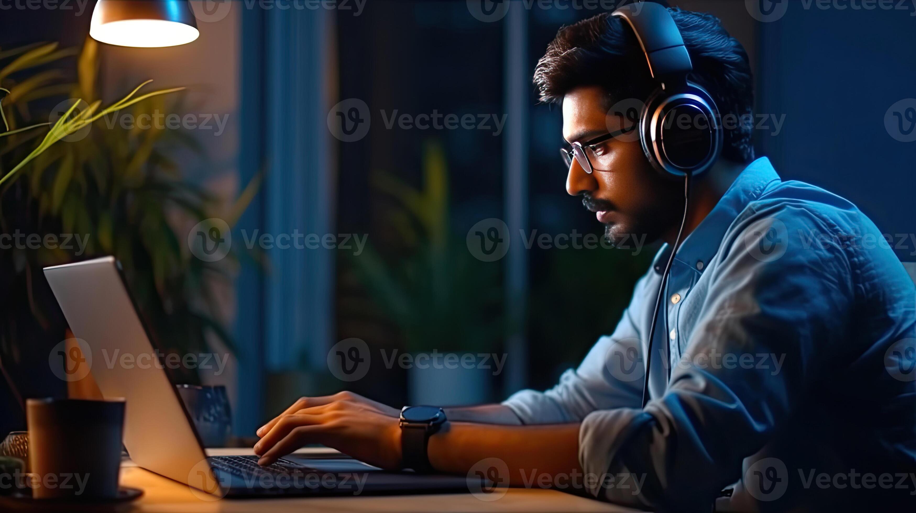 A young indian student using computer remote studying, watching online