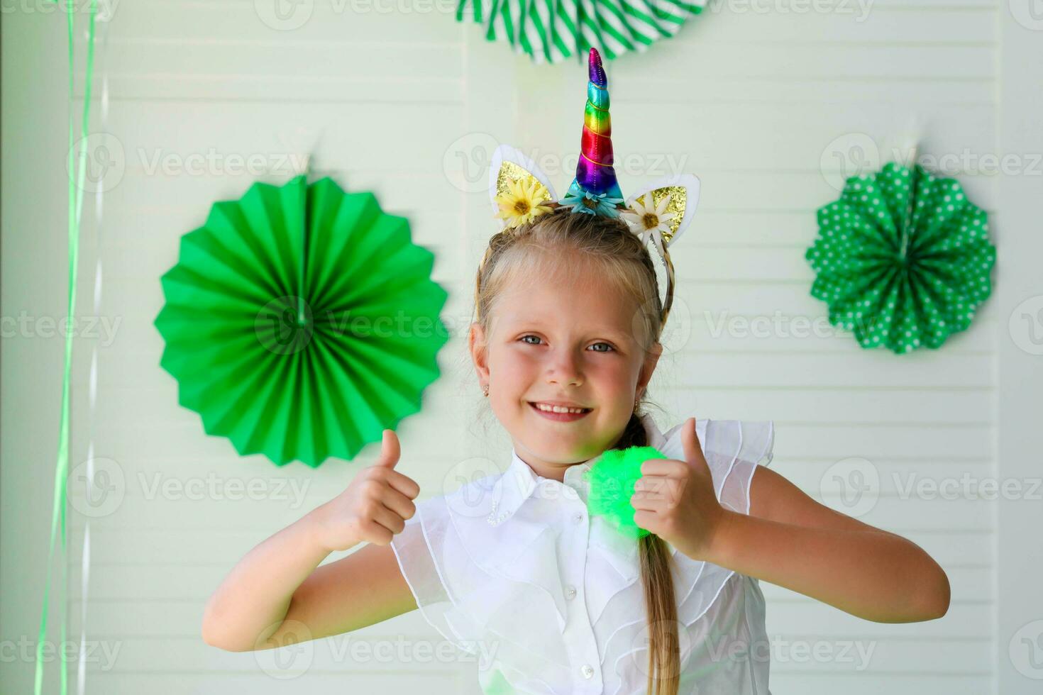 A little girl with a unicorn hoop . Birthday for children. St. Patrick is Day Celebration photo