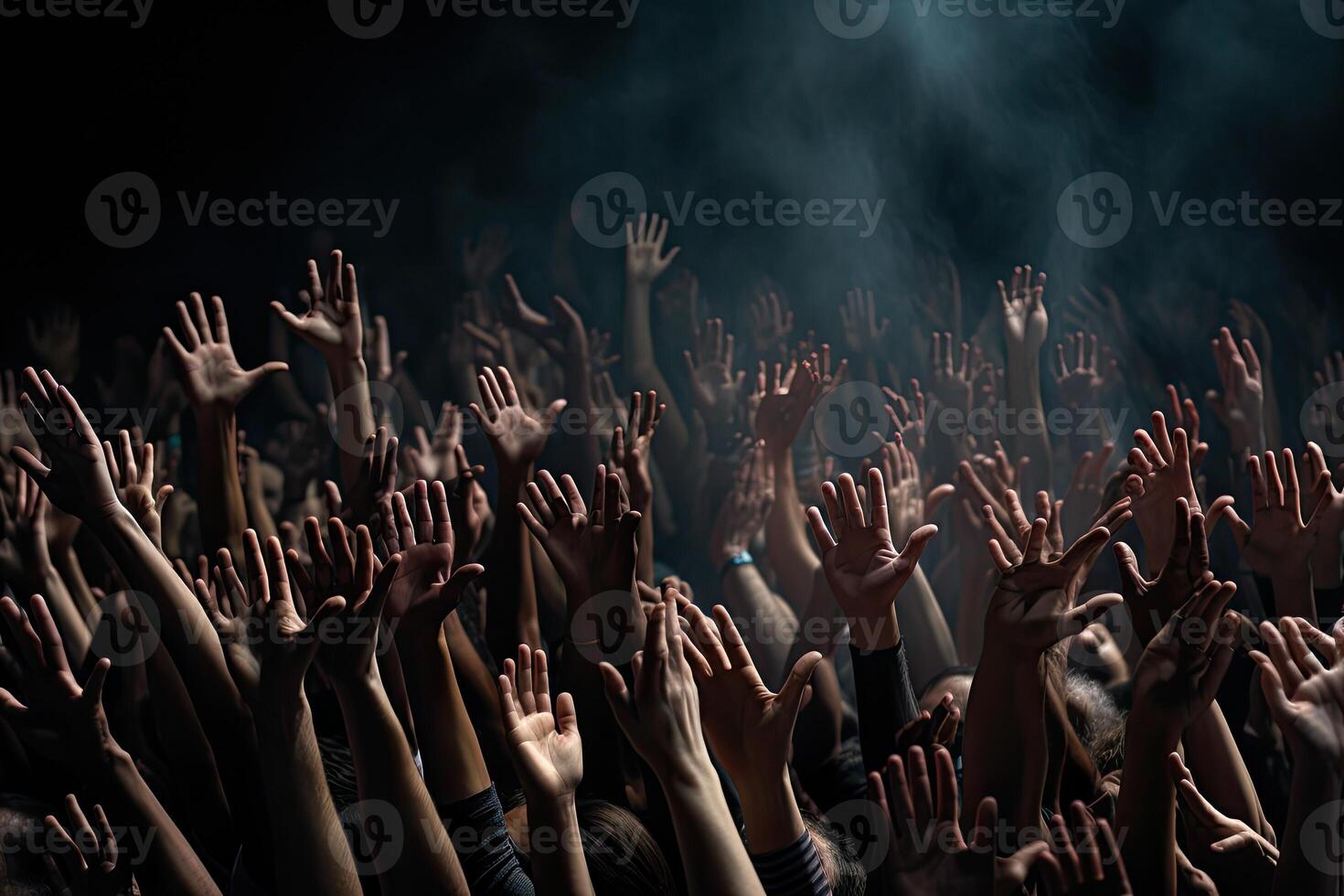 Group of people hands raised up in the air on a black background. . photo