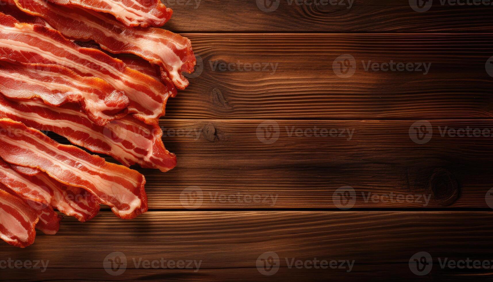 Slices of bacon on wooden background. Top view with copy space. . photo
